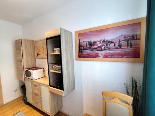 a room with a cabinet and a picture on the wall at City Ferienhaus Vulkaneifel in Daun