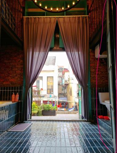 an open door to a room with a window at Nhà sách Mão's homestay I in Hanoi