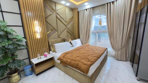 a bedroom with a bed and a large window at ParkView City Lake Facing in Malot