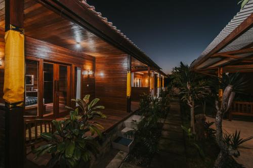 a wooden house with plants in front of it at Kubu Semer Badung in Nusa Lembongan