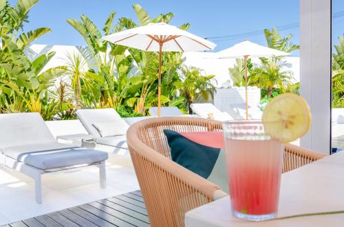 a drink on a table with a lemon slice at Villa Sound of the Sea by Portugal Collection in Aljezur