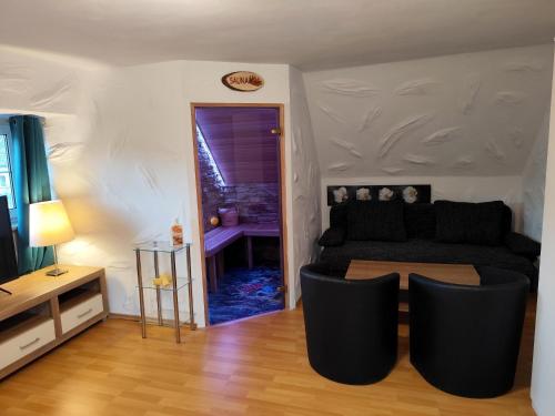 a living room with a couch and a table at City Ferienhaus Vulkaneifel in Daun
