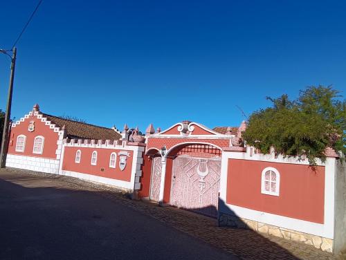 a red and white fence in front of a house at Casa de Artista in Figueiró dos Vinhos