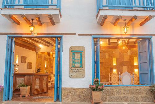 a building with blue doors and windows and a patio at Hotel Boutique Casa Encanto Barichara in Barichara