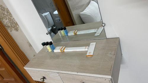 a dresser with a mirror and some knives at Midways Guest House and Hotels in Islamabad