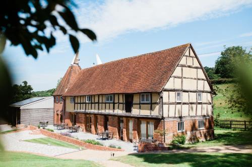 a large brick building with a brown roof at 1 & 2 bedroom Weaver's Cottages at Frame Farm in Benenden