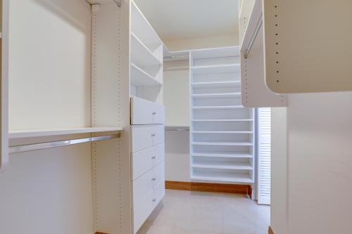 a walk in closet with white shelves at Spacious and Modern Apt with Spa Access in Wellington! in Wellington
