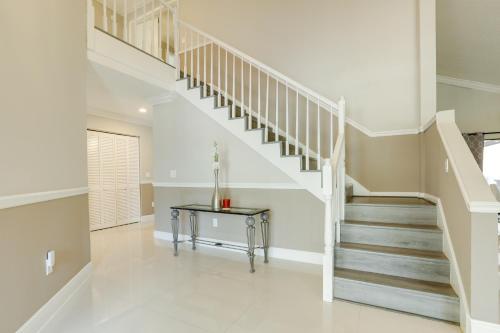 a white staircase in a home with a table at Spacious and Modern Apt with Spa Access in Wellington! in Wellington