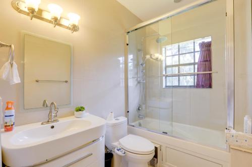a bathroom with a toilet and a sink and a shower at Sauna and Pool Access Luxe Wellington Apt! in Wellington