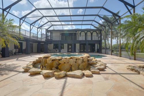 a large house with a pool and a building at Sauna and Pool Access Luxe Wellington Apt! in Wellington