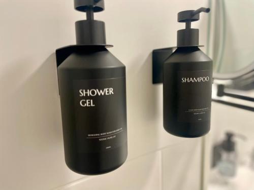 two bottles of shampoo and a mirror on a sink at Komm & Bleib in Falkensee
