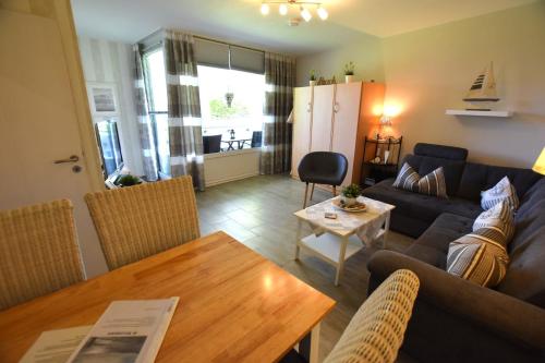 a living room with a couch and a table at FeWo Sol Mare Whg2 in Kellenhusen