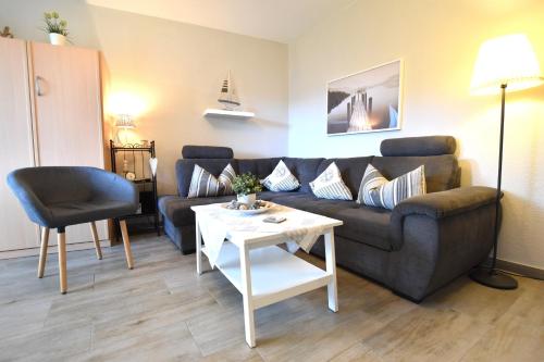 a living room with a couch and a table at FeWo Sol Mare Whg2 in Kellenhusen