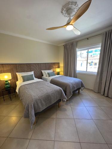 a bedroom with two beds and a ceiling fan at Villa Victoria With Heated Pool in Callao Salvaje