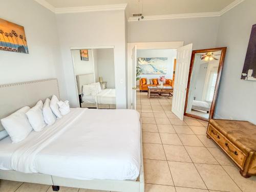 a bedroom with a white bed and a mirror at 3bd Little Italy Cottage A++ Location in San Diego