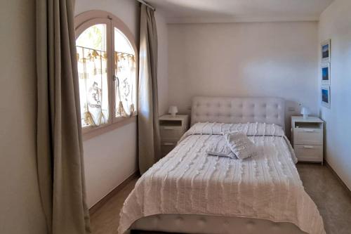 a white bedroom with a bed and a window at Aqua di Puglia Luxury & Pool - Salento Selection in Nardò