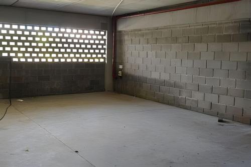 an empty room with a brick wall and a window at City Zen Studios in Sao Jose do Rio Preto