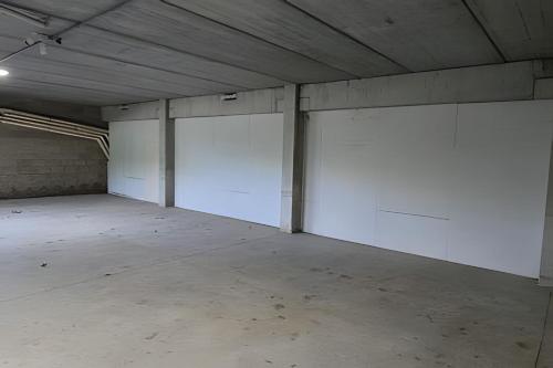 an empty parking garage with two white garage stalls at City Zen Studios in Sao Jose do Rio Preto