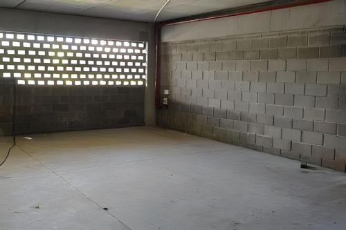 an empty room with a brick wall and a window at City Zen Studios in Sao Jose do Rio Preto