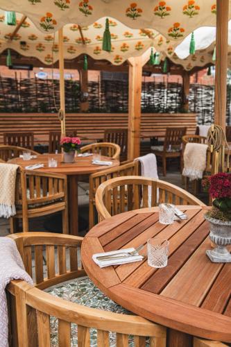a wooden table and chairs in a restaurant at Bel and The Dragon-Odiham in Odiham