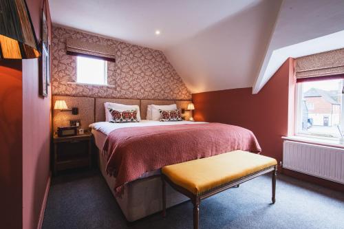 a bedroom with a large bed and a window at Bel and The Dragon-Odiham in Odiham