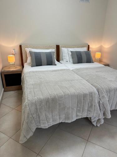 a bedroom with two beds and two lamps on tables at Villa Victoria With Heated Pool in Callao Salvaje