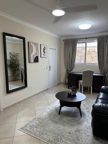 a living room with a couch and a table at Villa Victoria With Heated Pool in Callao Salvaje