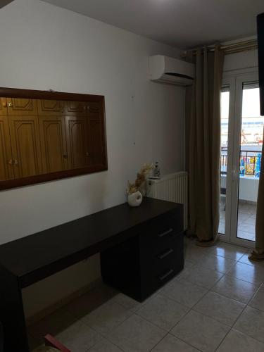a living room with a black desk and a window at Elpida view apartment in Kyllini