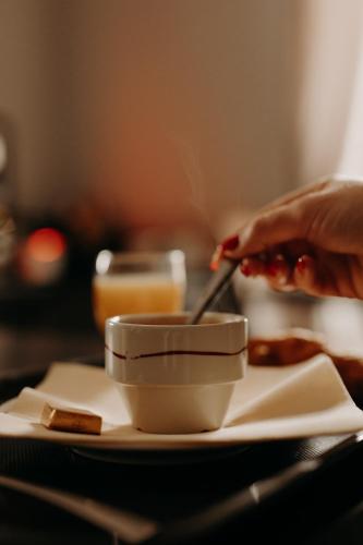 a person eating food from a bowl on a plate at Logis - Hotel Restaurant du Parc in Cransac
