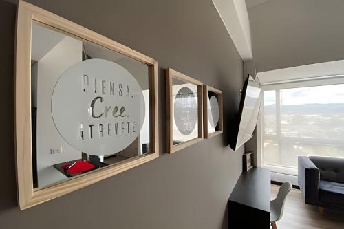 a living room with three pictures on the wall at Domus Suites Chia in Chía