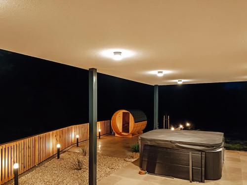 a room with a bed in the middle of a patio at Villa Waldblick in Wagerberg