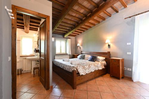a bedroom with a large bed in a room at La Grande Via, ospitalità in Maremma in Montemerano