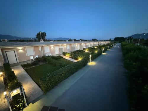 a long walkway with a building at night at Agri-Resort Luxury Farm in Marigliano