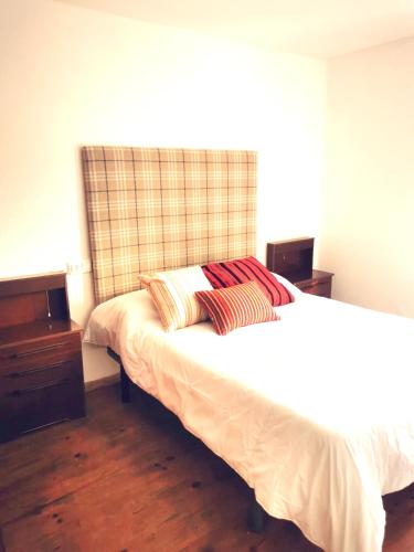 a bedroom with a bed with two pillows on it at Apartamento MIZA in Ponferrada