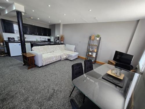 a bedroom with a bed and a table and a kitchen at Imperial Apartment sea view Margate in Margate