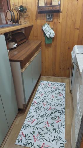 a kitchen with a rug on the floor in a kitchen at Wooden house Ada in Ada Ciganlija