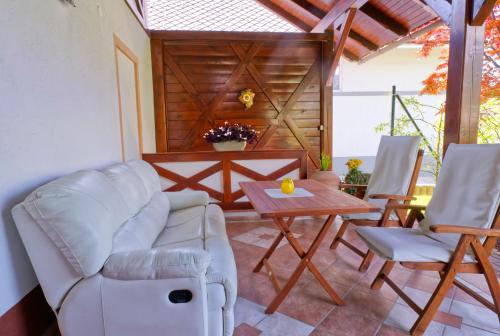 a living room with a couch and a table and chairs at Apartment Zupan in Begunje na Gorenjskem