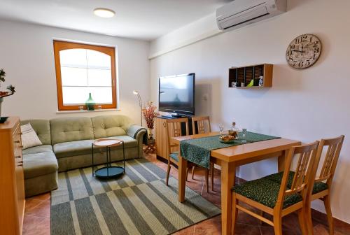 a living room with a couch and a table at Apartment Zupan in Begunje na Gorenjskem
