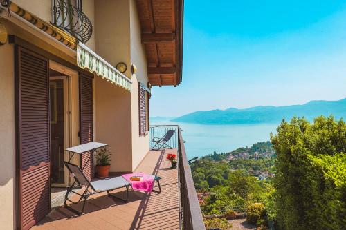 a balcony of a house with a table and chairs at Casetta di Rosetta in Arizzano