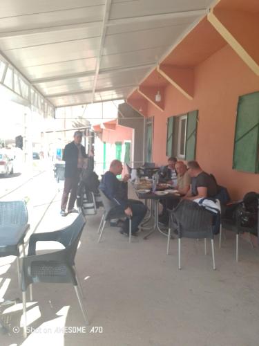 a group of people sitting at a table in a building at Rani hani chez ali in Tinerhir