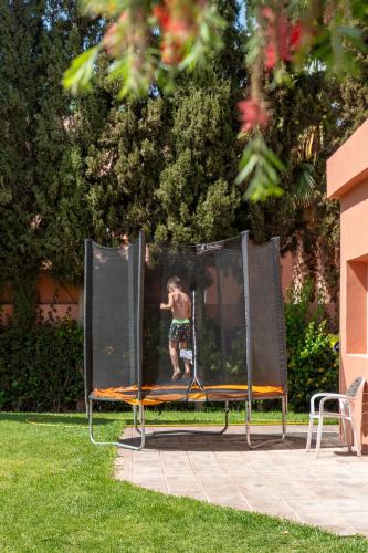 a young man is jumping on a board in a jump at Rose Aqua Park Hotel in Marrakesh