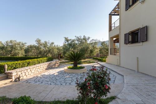 a courtyard of a house with a potted plant at Villa Callisti in Pylos
