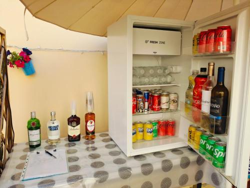 a refrigerator filled with lots of bottles and drinks at Maracuya House - Men Only in Torremolinos