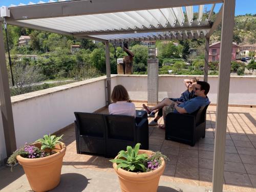 a group of people sitting on a patio at Casa San Rocco in Guardavalle