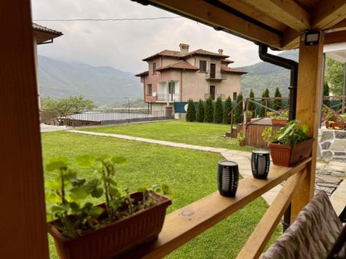 a view of a house from the porch of a house at Guest House Mihalkovo in Mikhalkovo