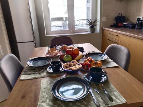 a table with plates and bowls of fruit on it at 1920 Classic in Kalamata