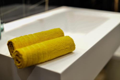 a yellow sponge sitting on top of a white counter at Isula SeaView Apartments in Isola delle Femmine