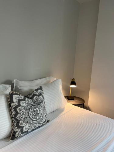 a bedroom with a bed with a pillow and a lamp at ALTHEA luxury suites and apartments in Plataria
