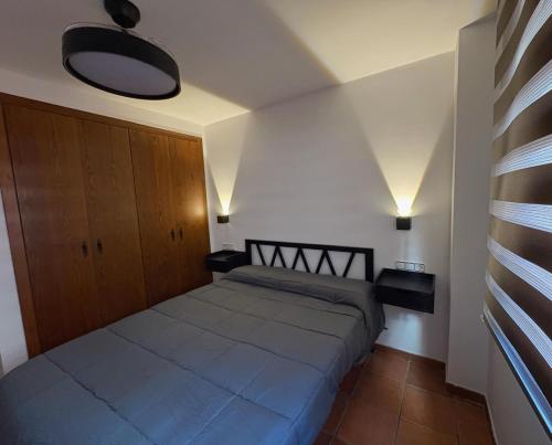 a bedroom with a large bed in a room at Piso bajo con terraza in Mora de Rubielos