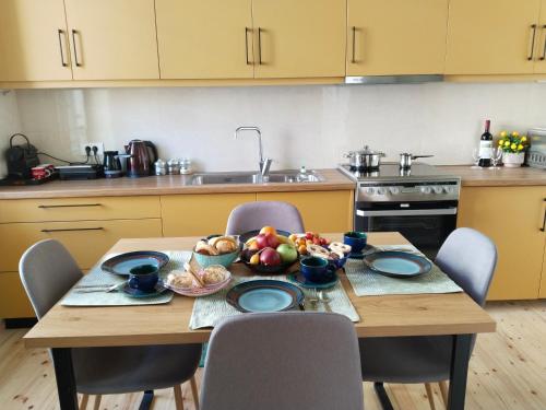 a kitchen with a table with a bowl of fruit on it at 1920 Classic in Kalamata